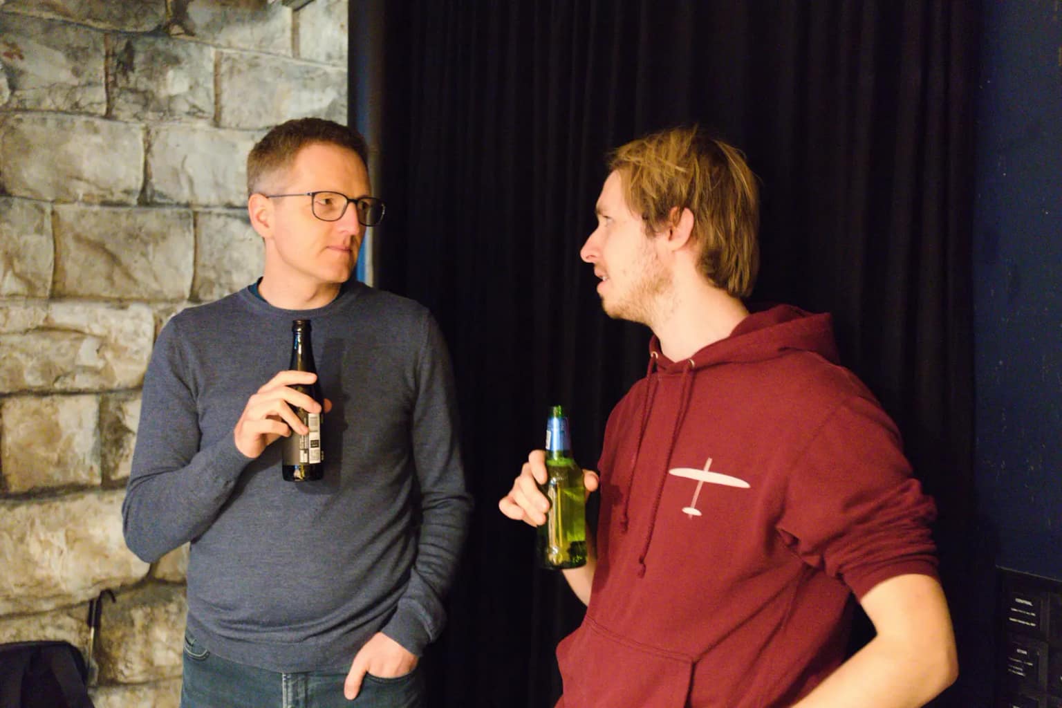 Two attendees talking before the talks